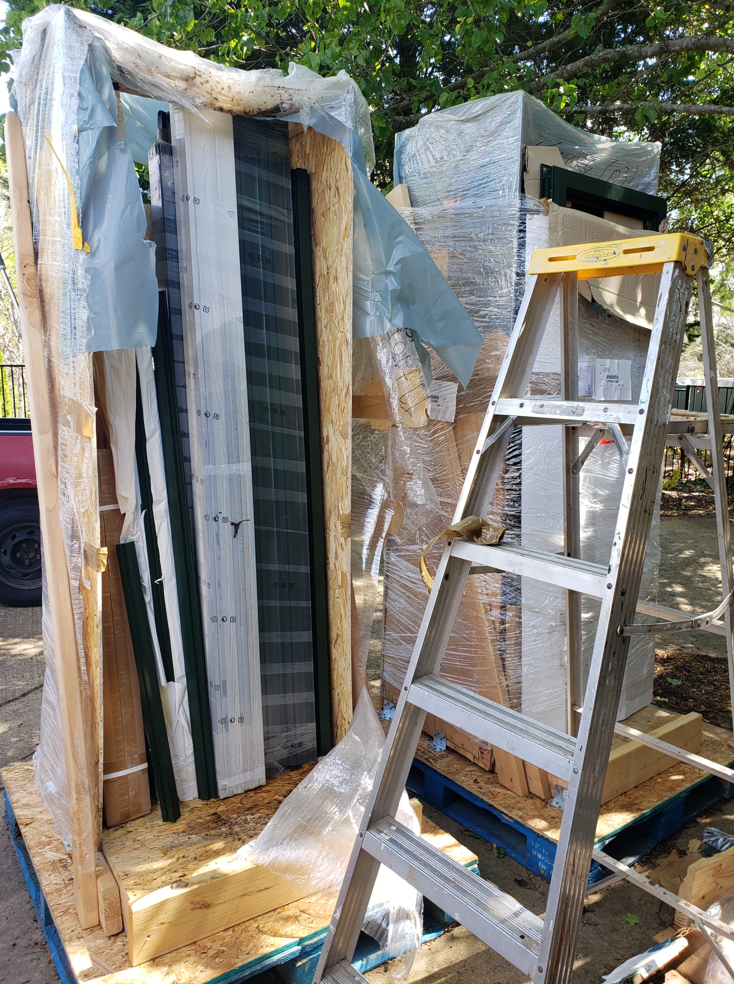 Greenhouse crates delivered to site, ready for professional assembly