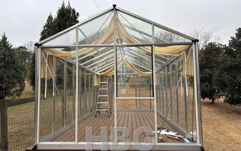 Royal Victorian VI36 all-glass greenhouse on a deck in Jackson County, GA